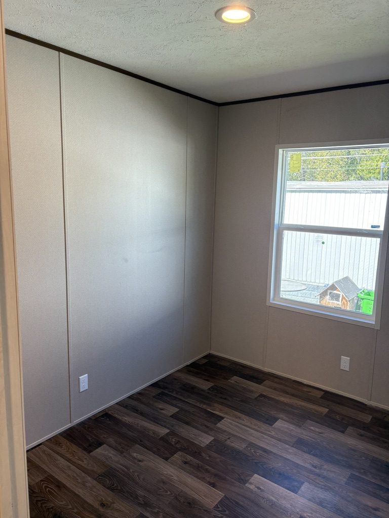Bedroom with large window and new flooring