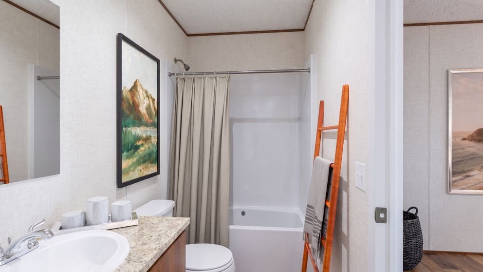 Factory photo of the primary bathroom with tub and shower